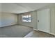 Bright living room features neutral carpeting and paint and a front-facing window at 4536 W Bloomfield Rd, Glendale, AZ 85304