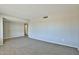 Living room area with neutral colored walls, carpet and wood laminate flooring at 4536 W Bloomfield Rd, Glendale, AZ 85304