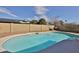 Backyard pool is surrounded by a block fence for privacy, and is complimented by mature landscaping at 4536 W Bloomfield Rd, Glendale, AZ 85304