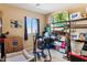 A cluttered spare bedroom with a window, shelving units, and exercise equipment in disarray at 4960 S Huachuca Pl, Chandler, AZ 85249