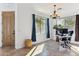 Bright dining room with natural light, modern chandelier, and view of landscaped yard at 4960 S Huachuca Pl, Chandler, AZ 85249