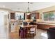 Eat-in kitchen features dark wood cabinetry, tile backsplash, stainless steel appliances, and pendant lighting at 4960 S Huachuca Pl, Chandler, AZ 85249