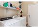 Functional laundry room equipped with a modern washer, dryer, and ample storage space on shelving at 4960 S Huachuca Pl, Chandler, AZ 85249