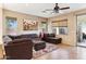 Cozy living room with comfortable seating, a ceiling fan, and plenty of natural light at 4960 S Huachuca Pl, Chandler, AZ 85249