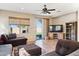 Comfortable living room with ceiling fan, tile flooring, and sliding door access to the outdoor space at 4960 S Huachuca Pl, Chandler, AZ 85249