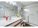 Well-lit bathroom with a shower, decorated mirror and sink with wood cabinets at 542 S Higley Rd # 83, Mesa, AZ 85206