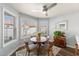 Cozy dining area with natural light, wood table, ceiling fan and seating for four at 542 S Higley Rd # 83, Mesa, AZ 85206