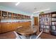 Community library with bookshelves, a table with chairs, and a countertop with cabinets at 542 S Higley Rd # 83, Mesa, AZ 85206