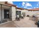 Charming front patio with wrought iron gate, outdoor seating and desert landscaping at 542 S Higley Rd # 83, Mesa, AZ 85206