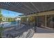 Gorgeous covered patio featuring a luxurious pool and seamless indoor-outdoor flow through sliding glass doors at 5518 E Cambridge Ave, Phoenix, AZ 85008