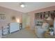 Comfortable Bedroom with soft pink walls, well-organized storage, and a cozy rocking chair at 5518 E Cambridge Ave, Phoenix, AZ 85008