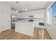 Modern kitchen featuring stainless steel appliances, white cabinets, and a center island at 625 N Vine St, Chandler, AZ 85225