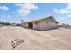 Back exterior of single story home with desert landscaping and covered patio at 6308 E Billings St, Mesa, AZ 85205