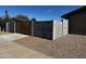 Backyard view highlighting a privacy fence with a wooden gate and rock landscaping at 6308 E Billings St, Mesa, AZ 85205