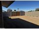 Large backyard featuring block fencing and a wooden gate for added privacy at 6308 E Billings St, Mesa, AZ 85205