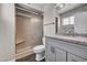 Bathroom vanity with granite top, neutral wall color, tile shower with bench at 6308 E Billings St, Mesa, AZ 85205