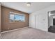 Bedroom showcasing new carpet, neutral wall color, large window and closet at 6308 E Billings St, Mesa, AZ 85205