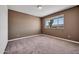 Bedroom featuring neutral color scheme, carpet flooring, and view of desert landscape at 6308 E Billings St, Mesa, AZ 85205