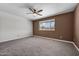 Spacious bedroom featuring new carpet, neutral wall color, large window and ceiling fan at 6308 E Billings St, Mesa, AZ 85205