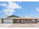 Charming single-story brick home featuring an attached two-car garage and tidy desert landscaping at 6308 E Billings St, Mesa, AZ 85205