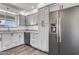 Beautiful kitchen with stainless steel refrigerator, granite countertops, and gray cabinets at 6308 E Billings St, Mesa, AZ 85205