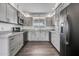 Updated kitchen featuring stainless steel appliances, granite counters, and gray cabinetry at 6308 E Billings St, Mesa, AZ 85205