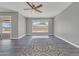 Open-concept living area with vinyl floors, neutral wall color, ceiling fan, and natural light at 6308 E Billings St, Mesa, AZ 85205