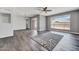 Living room featuring vinyl flooring, neutral paint color, ceiling fan, and backyard access at 6308 E Billings St, Mesa, AZ 85205