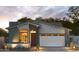 Beautiful single-story home with a red door, large window, and a white garage door and professional landscaping at 6710 N 9Th Dr, Phoenix, AZ 85013