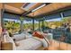 Sunlit bedroom featuring two twin beds, floor-to-ceiling windows, and scenic views of the surrounding landscape at 7686 E Stagecoach Pass Rd, Carefree, AZ 85377