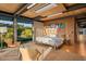 Bedroom with natural light, view of desert landscape, modern artwork and bed at 7686 E Stagecoach Pass Rd, Carefree, AZ 85377