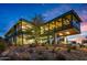 Modern glass-walled home with desert landscaping and stunning sunset views at 7686 E Stagecoach Pass Rd, Carefree, AZ 85377