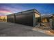 Modern detached garage with a paved driveway at 7686 E Stagecoach Pass Rd, Carefree, AZ 85377