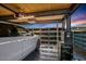 Modern garage with a white car, automated door, and tool cabinets against a backdrop of a stunning sunset at 7686 E Stagecoach Pass Rd, Carefree, AZ 85377