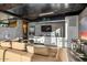 Modern living room with concrete walls, a sleek black countertop bar, and a comfortable beige leather sofa at 7686 E Stagecoach Pass Rd, Carefree, AZ 85377