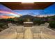 Serene covered patio with mountain views and a cozy fire pit at 7686 E Stagecoach Pass Rd, Carefree, AZ 85377