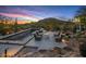 Relaxing outdoor pool area featuring comfortable seating, desert landscaping, and mountain views at 7686 E Stagecoach Pass Rd, Carefree, AZ 85377