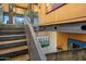 Metal staircase with wire mesh railing offering a view of artwork and concrete walls on the lower level at 7686 E Stagecoach Pass Rd, Carefree, AZ 85377