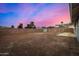 Backyard featuring a block fence and sparse desert landscaping at 7906 W Catalina Dr, Phoenix, AZ 85033