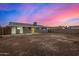 Twilight view of the home's backyard and covered patio at 7906 W Catalina Dr, Phoenix, AZ 85033