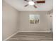 Neutral bedroom featuring new flooring and natural light from a window at 7906 W Catalina Dr, Phoenix, AZ 85033