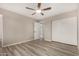 Bedroom features neutral walls, closet, new flooring, and a ceiling fan at 7906 W Catalina Dr, Phoenix, AZ 85033