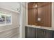 Inviting entryway with attractive cabinet and shelving design, alongside modern lighting fixture at 7906 W Catalina Dr, Phoenix, AZ 85033