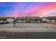 Charming single-story home featuring stylish gray paint, white trim windows, and a low-maintenance rock front yard at 7906 W Catalina Dr, Phoenix, AZ 85033