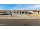 Charming single-story home featuring stylish gray paint, white trim windows, and a low-maintenance rock front yard at 7906 W Catalina Dr, Phoenix, AZ 85033