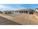 Charming single-story home featuring stylish gray paint, white trim windows, and a low-maintenance rock front yard at 7906 W Catalina Dr, Phoenix, AZ 85033