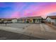 Charming single-story home featuring stylish gray paint, white trim windows, and a low-maintenance rock front yard at 7906 W Catalina Dr, Phoenix, AZ 85033