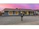 Charming single-story home featuring stylish gray paint, white trim windows, and a low-maintenance rock front yard at 7906 W Catalina Dr, Phoenix, AZ 85033