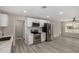 Well-appointed kitchen featuring stainless steel appliances, white cabinets, and decorative backsplash at 7906 W Catalina Dr, Phoenix, AZ 85033