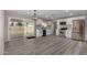 Spacious kitchen featuring white cabinets, stainless steel appliances and a sliding glass door to the backyard at 7906 W Catalina Dr, Phoenix, AZ 85033